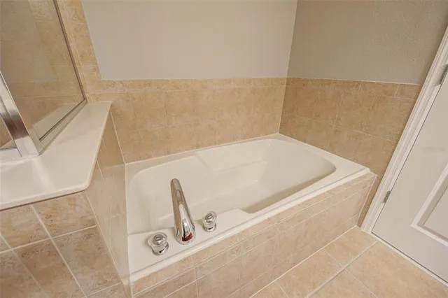 a bath tub sitting next to a white sink