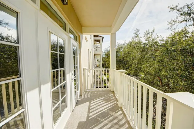 a view of a balcony with wooden floor and fence