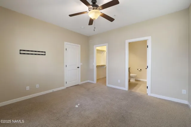 a view of an empty room with a ceiling fan