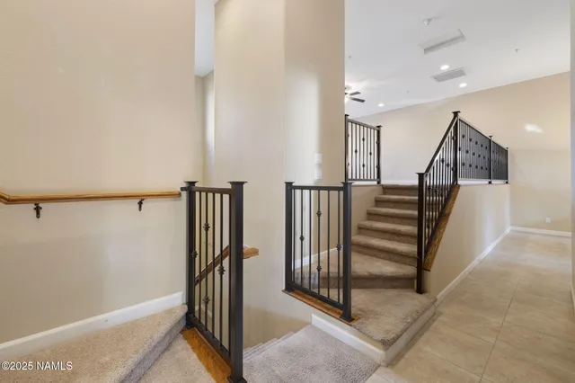 a view of an empty room with a window and fireplace