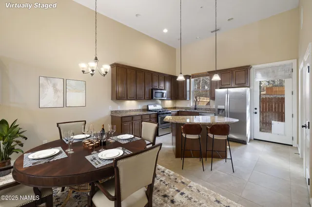a kitchen with a counter top space a sink stainless steel appliances and cabinets