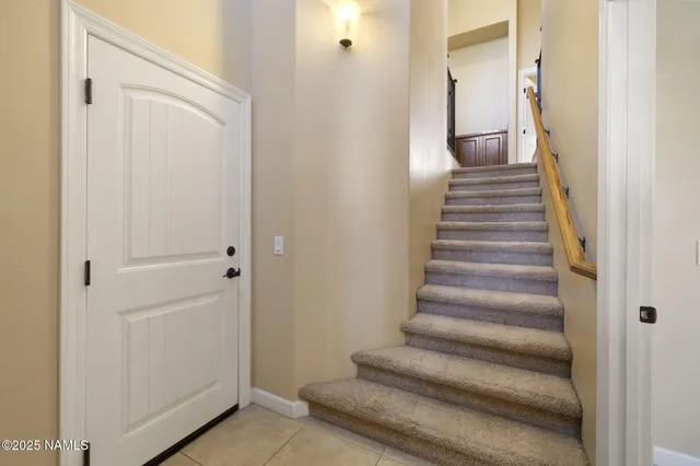 a view of a hallway with wooden floor and entryway