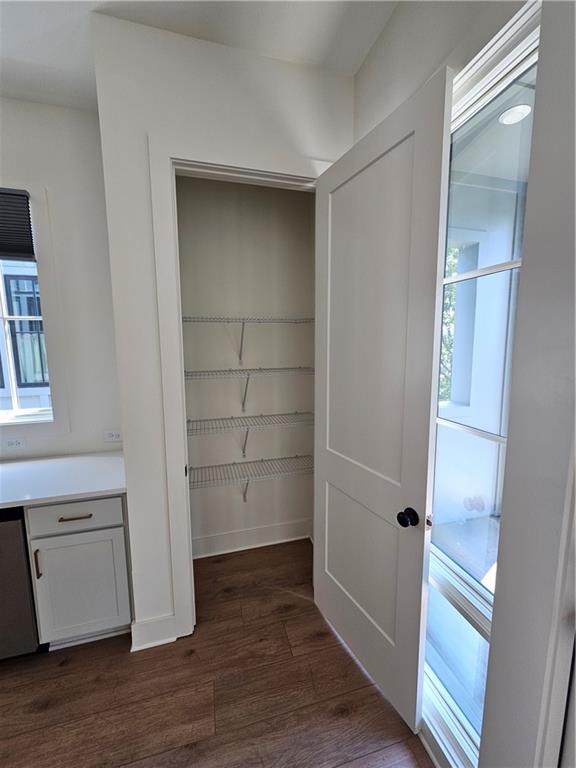 1294 Longreen Terrace Northwest, Unit 2 Atlanta, GA 30318 - Photo 8 of 25 an empty room with wooden floor & cabinet and a window