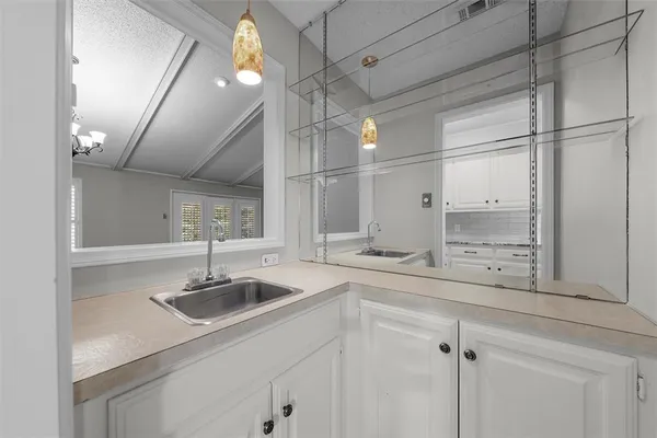 a kitchen with a sink cabinets and window
