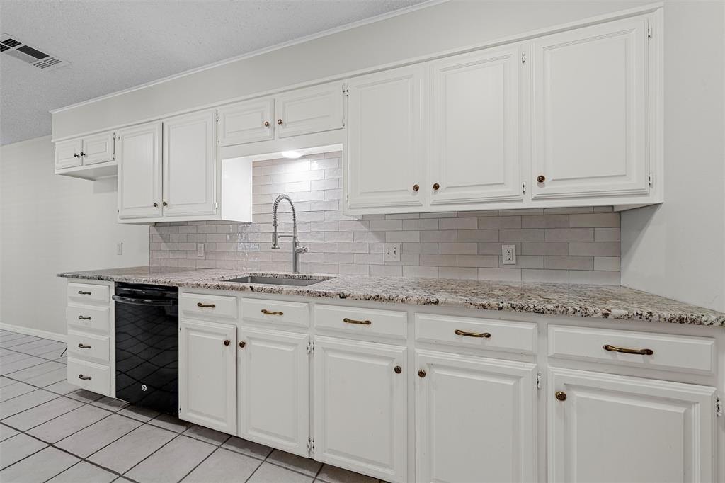 4108 Old Mill Road Waco, TX 76710 - Photo 13 of 40 a kitchen with granite countertop white cabinets and white appliances