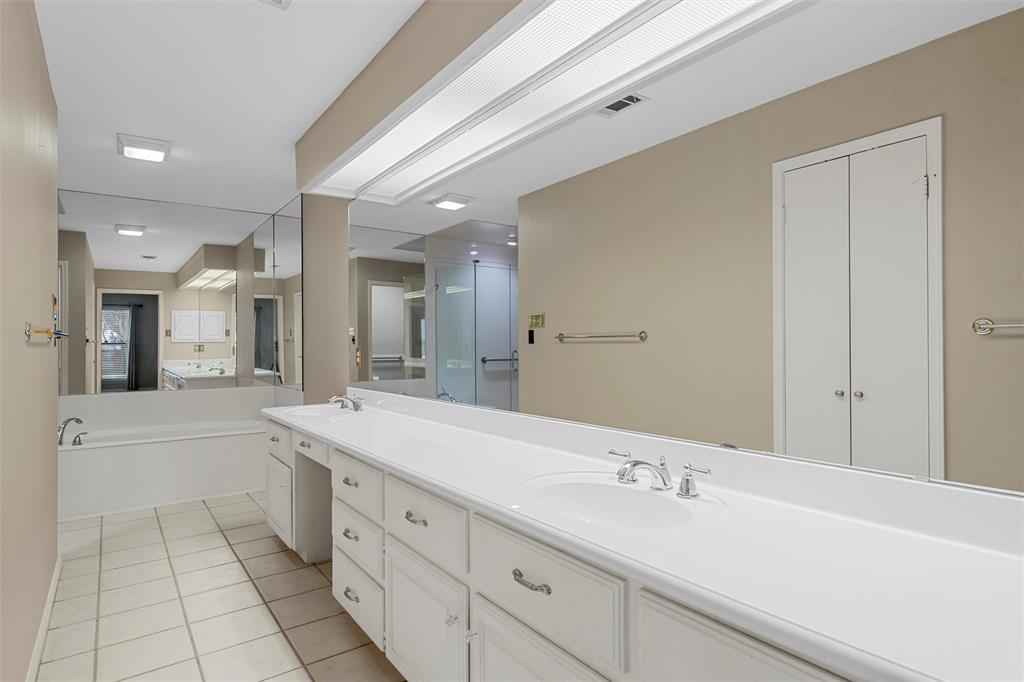 4108 Old Mill Road Waco, TX 76710 - Photo 19 of 40 a spacious bathroom with a sink a mirror and a bathtub