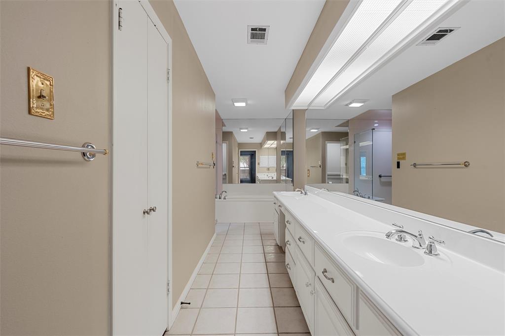 4108 Old Mill Road Waco, TX 76710 - Photo 20 of 40 a large white bathroom with a granite countertop sink a mirror and a shower