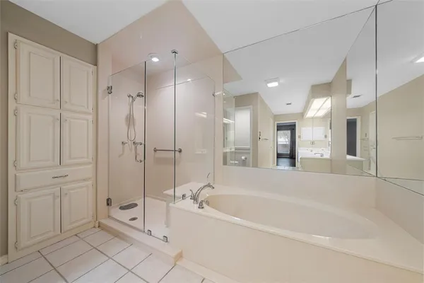 a spacious bathroom with a bathtub and a shower