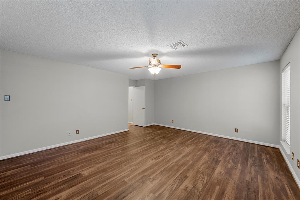 4108 Old Mill Road Waco, TX 76710 - Photo 24 of 40 a view of a room with wooden floor and a ceiling fan