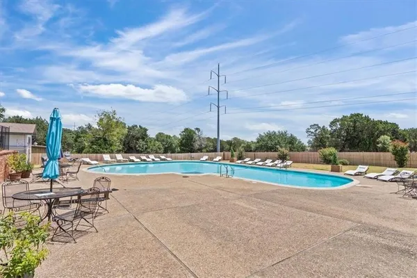 a view of a swimming pool with a lounge chairs