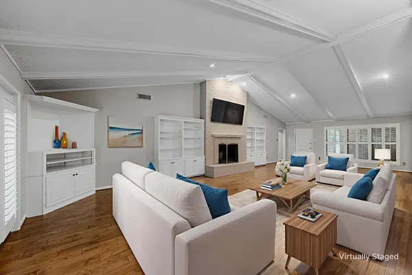a living room with furniture fireplace and a flat screen tv