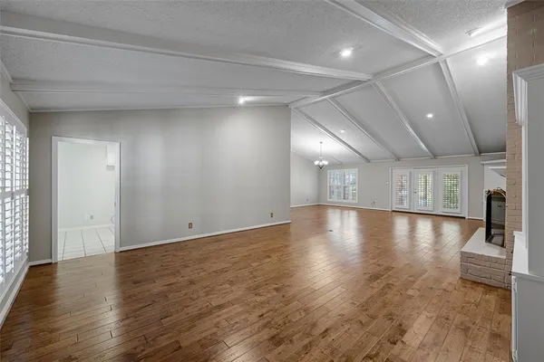 a view of a room with wooden floor