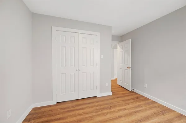 a view of an empty room and wooden floor