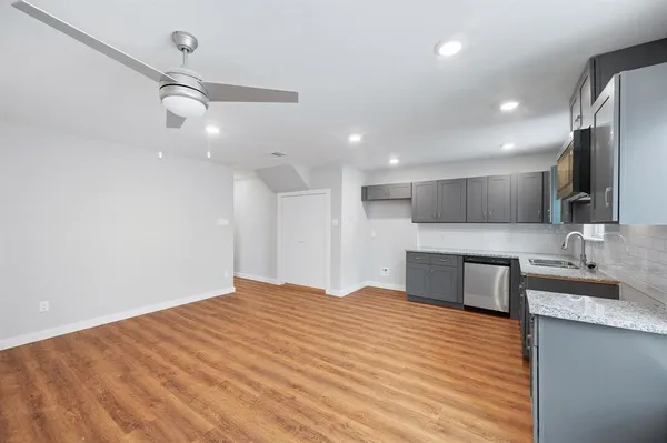 a large kitchen with kitchen island a sink stainless steel appliances and cabinets