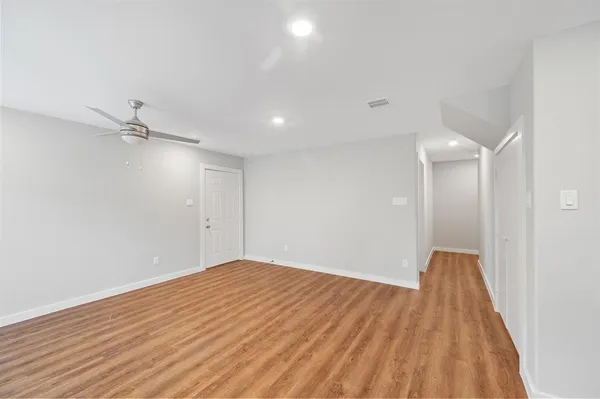 a view of empty room with wooden floor
