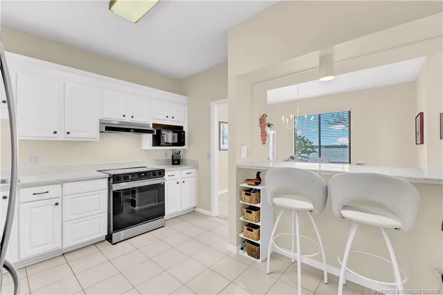 a bedroom with a large bed and a flat tv screen on dresser