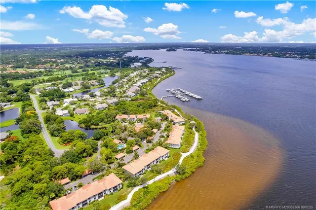 a front view of a house with a yard and potted plants