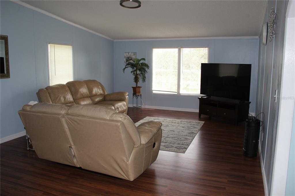 13127 Star Road Brooksville, FL 34613 - Photo 16 of 54 a living room with furniture and a flat screen tv