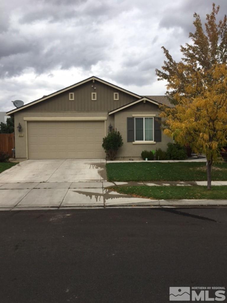 8945 Convair Way Reno, NV 89506 - Photo 1 of 26 a front view of a house with a garden and yard