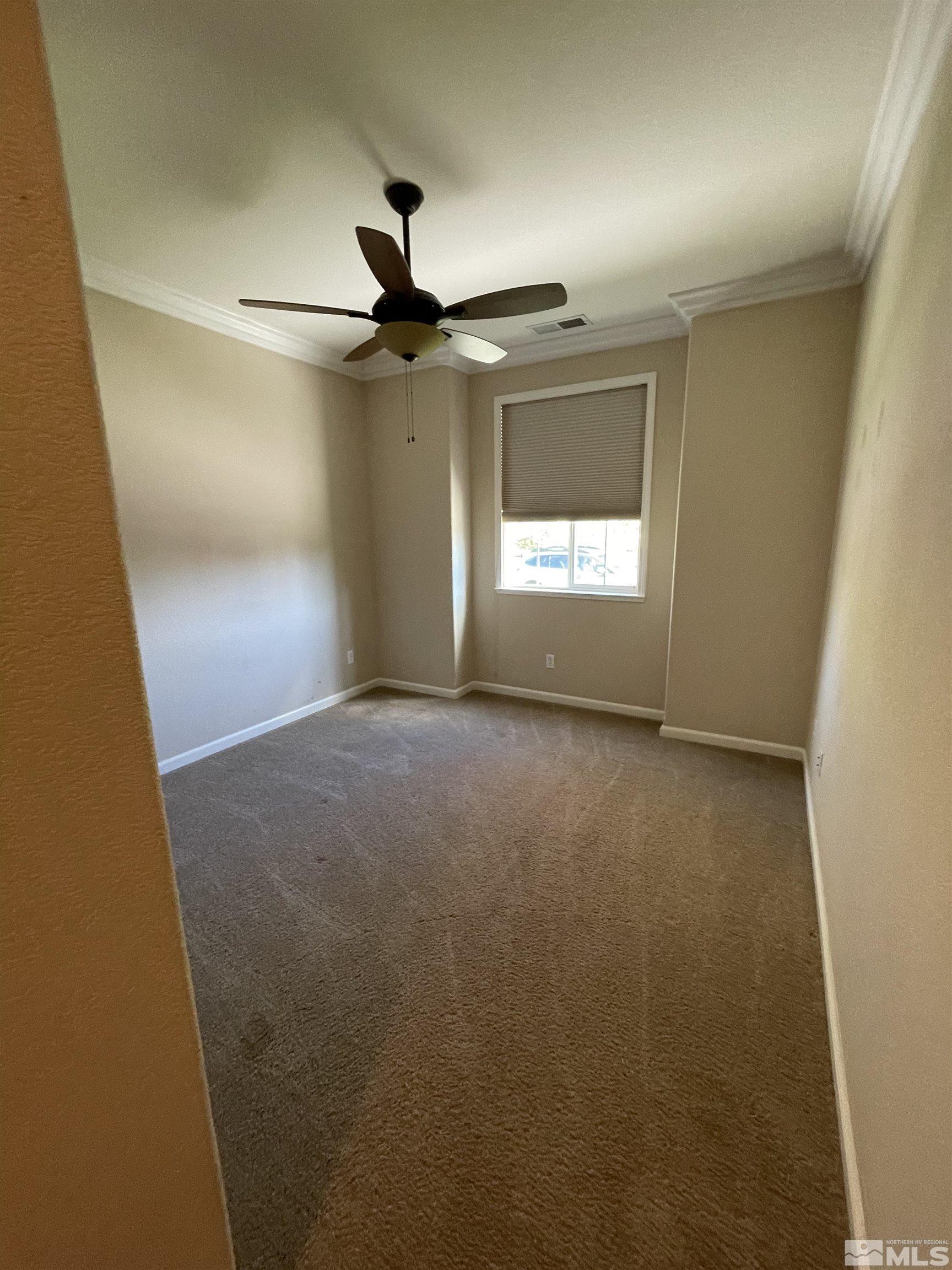 8945 Convair Way Reno, NV 89506 - Photo 15 of 26 en empty room with windows and fan