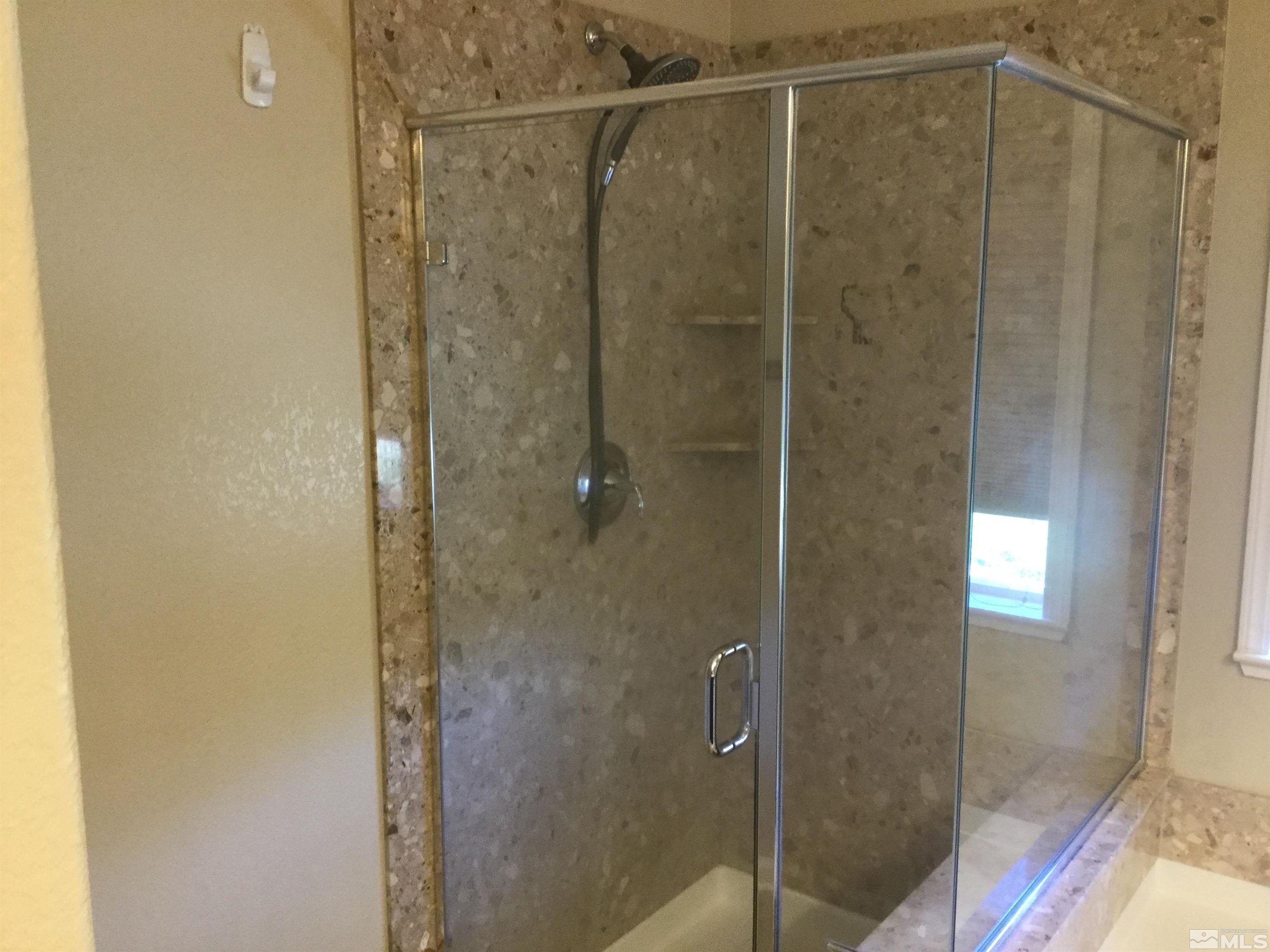 8945 Convair Way Reno, NV 89506 - Photo 20 of 26 a bathroom with a glass shower door