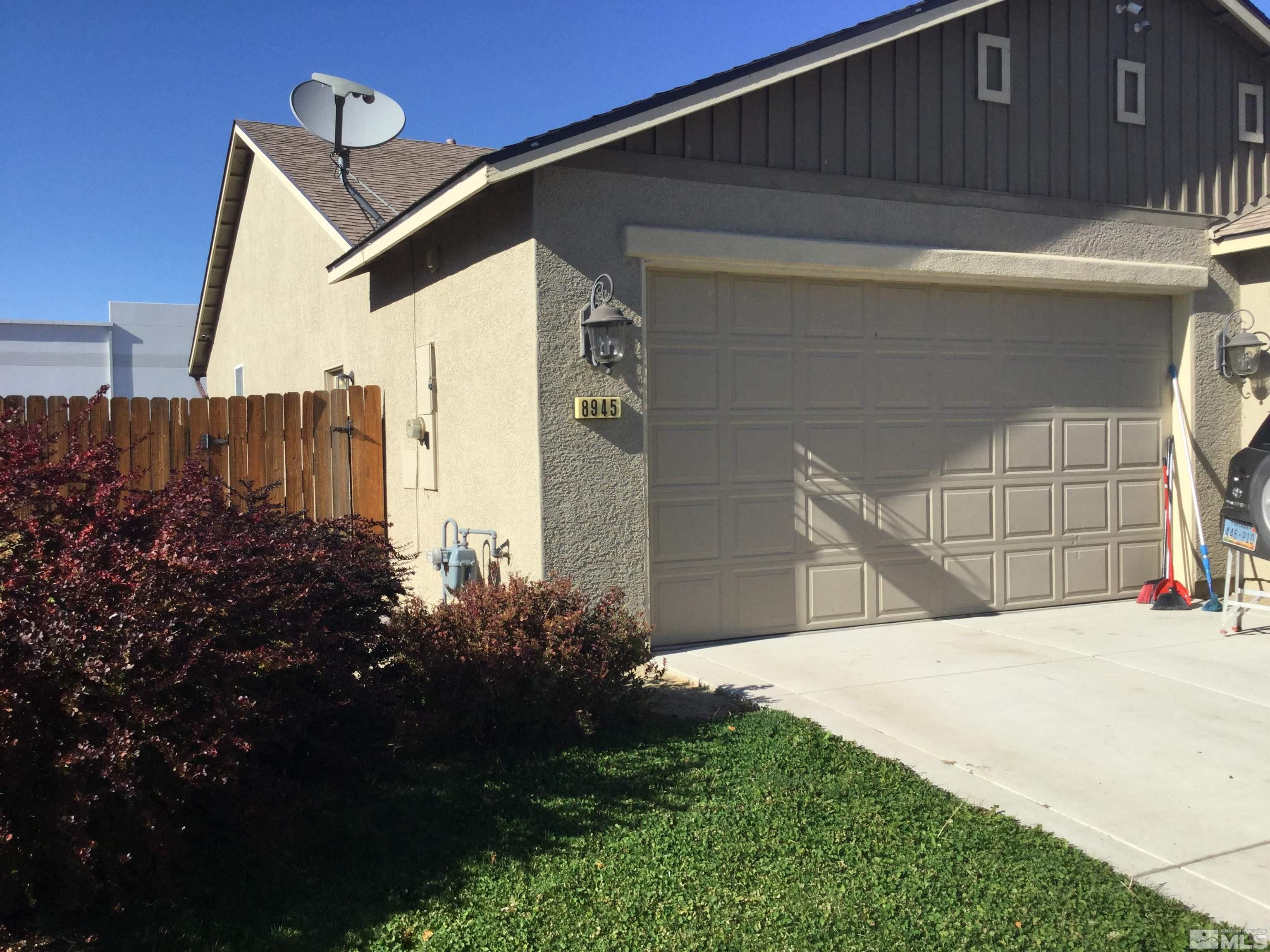 8945 Convair Way Reno, NV 89506 - Photo 2 of 26 a house with a small yard