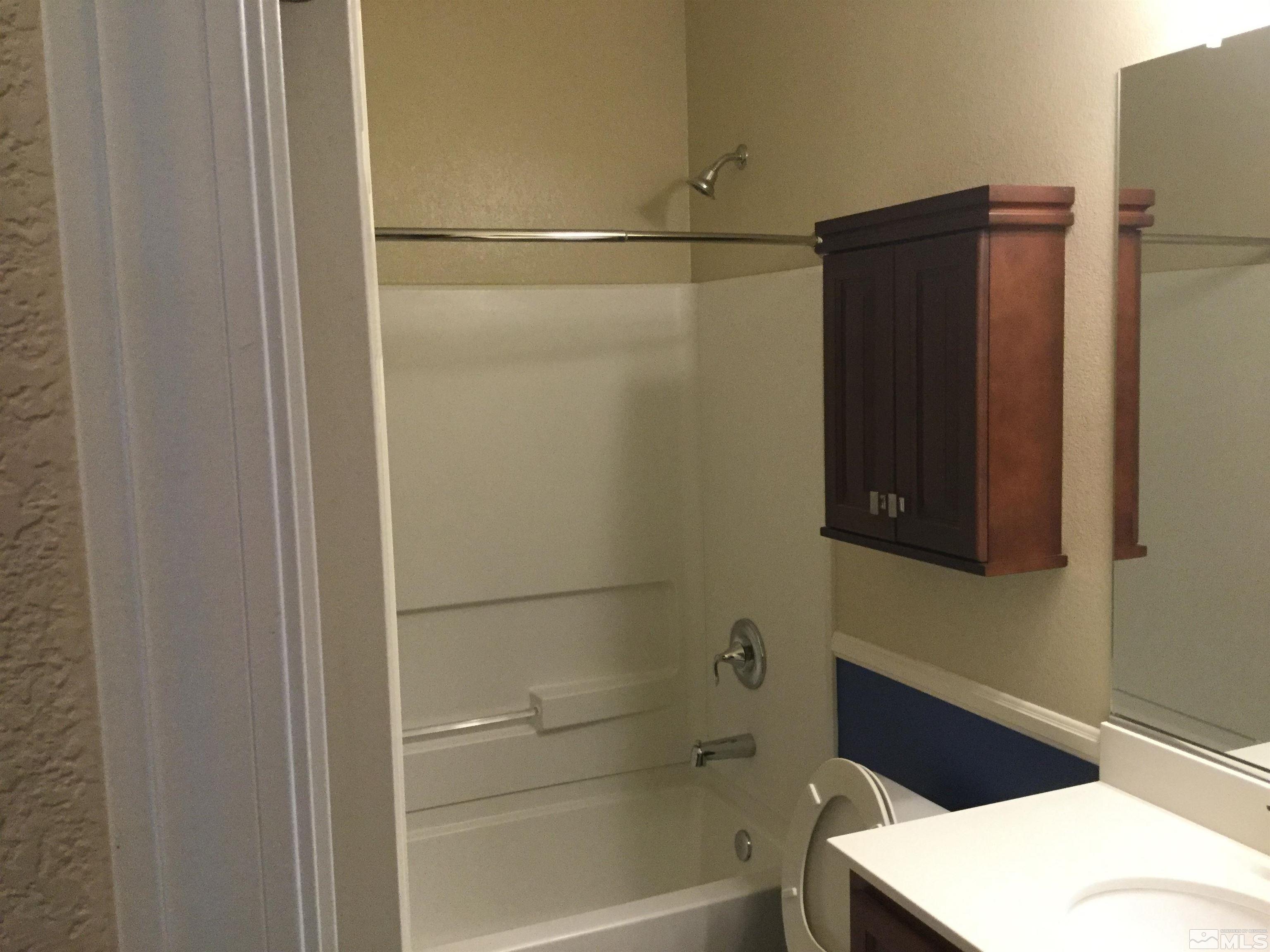 8945 Convair Way Reno, NV 89506 - Photo 21 of 26 a bathroom with a bathtub and a shower