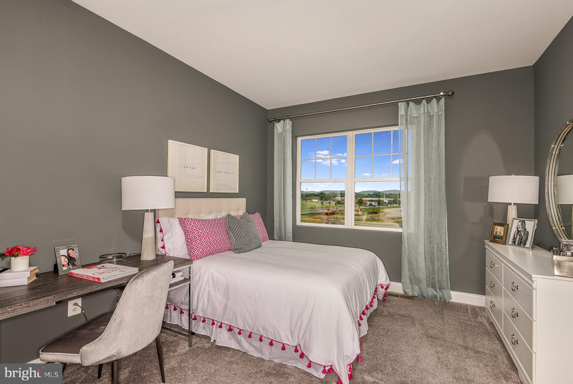 7103 Delegate Place Frederick, MD 21703 - Photo 14 of 23 a bedroom with a bed a table and a window