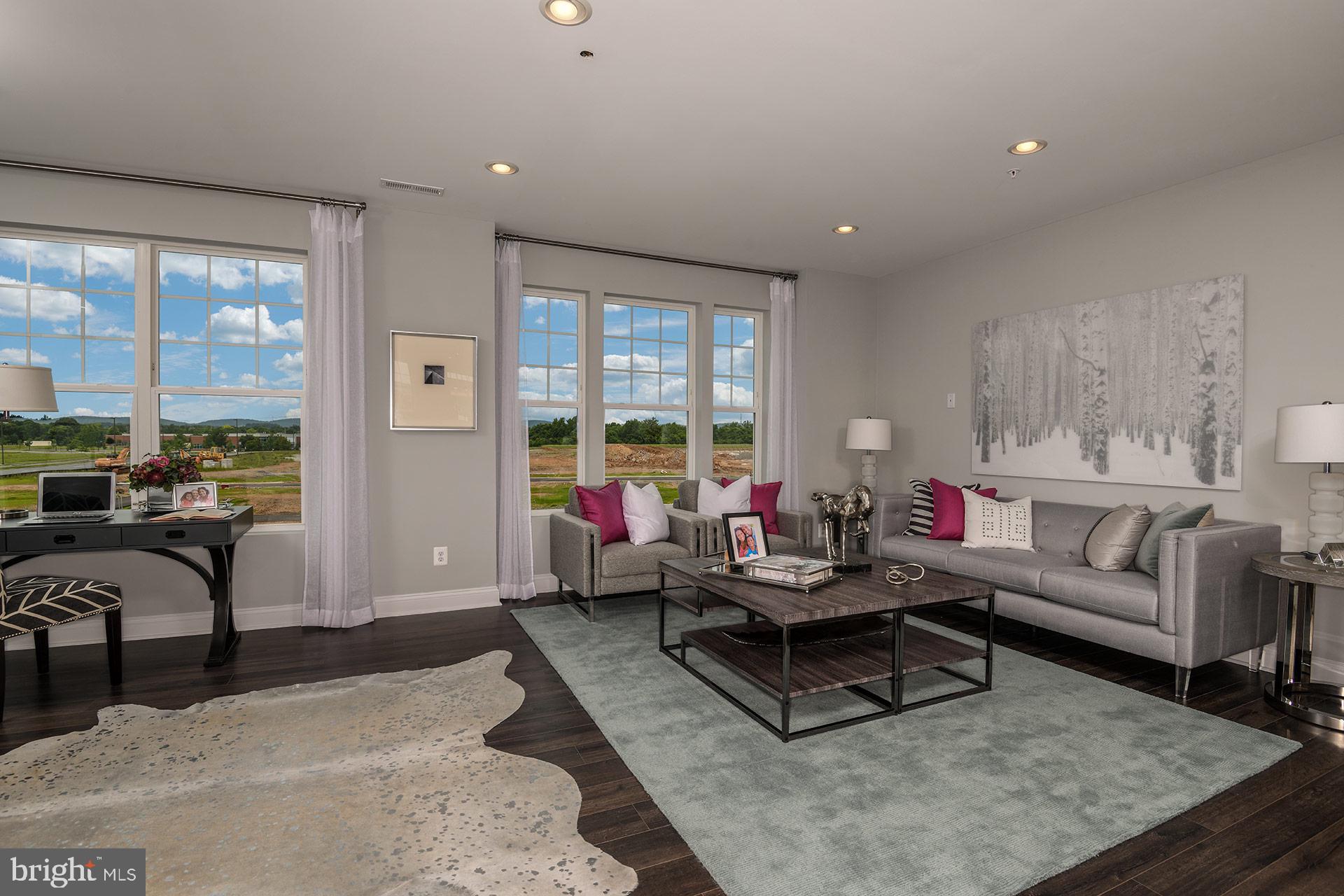 7103 Delegate Place Frederick, MD 21703 - Photo 5 of 23 a living room with furniture and a large window