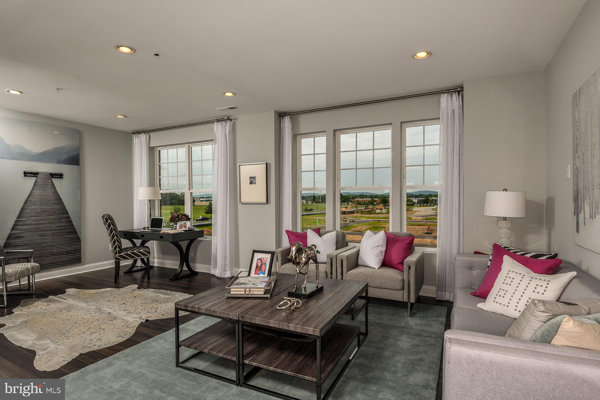 7103 Delegate Place Frederick, MD 21703 - Photo 6 of 23 a living room with furniture and large windows
