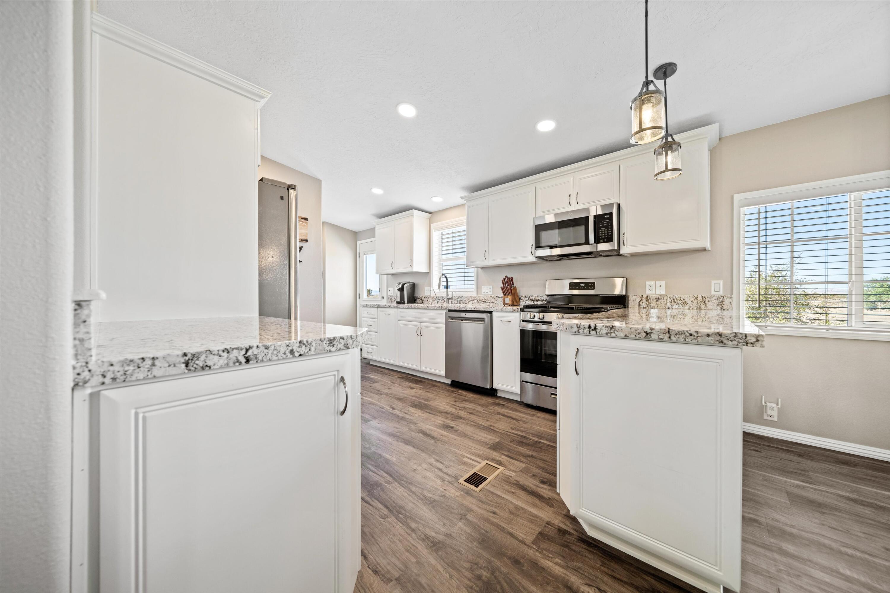 48197 Valley Center Road Newberry Springs, CA 92365 - Photo 13 of 32 a kitchen with a stove a sink and a refrigerator