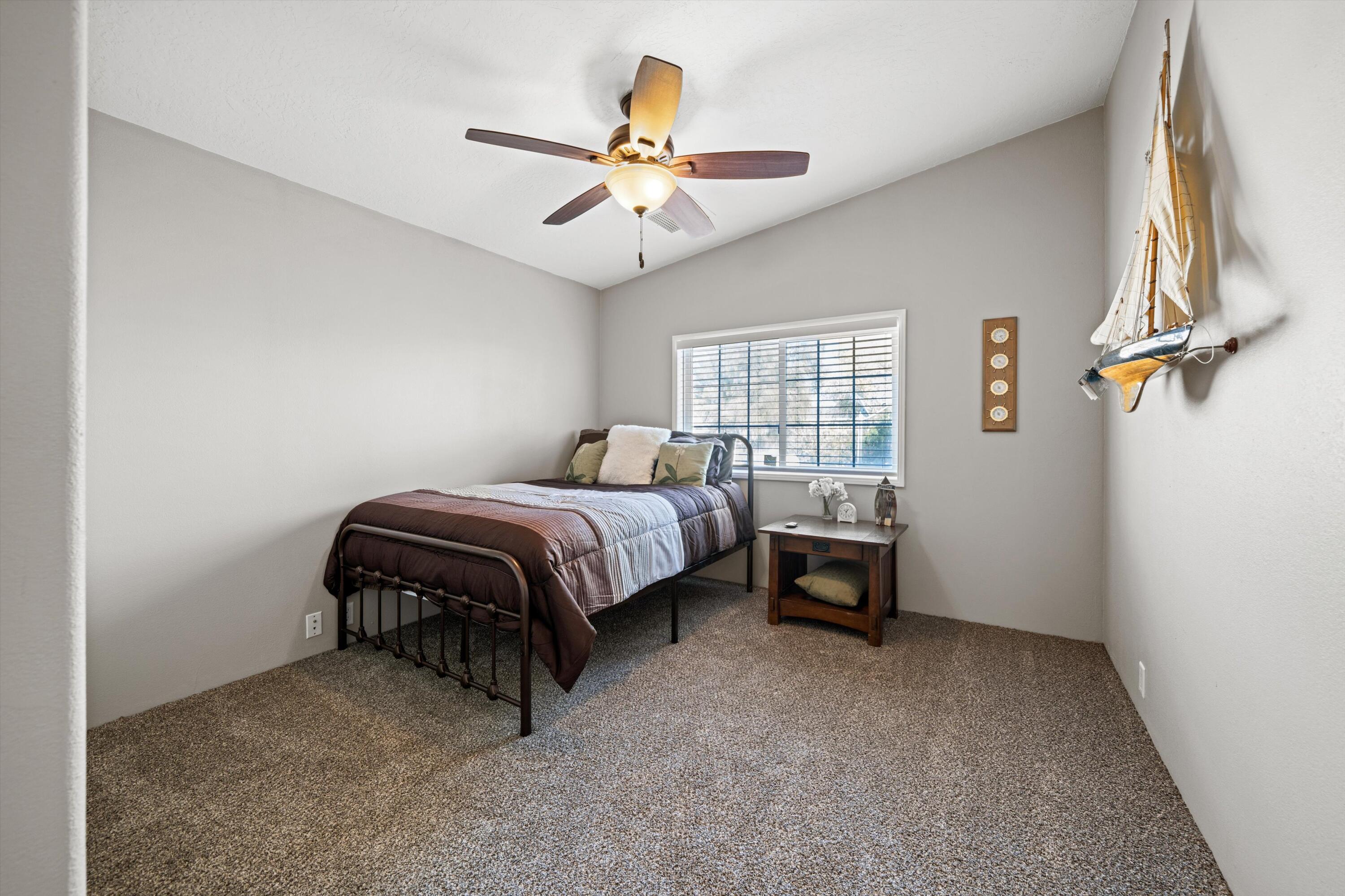 48197 Valley Center Road Newberry Springs, CA 92365 - Photo 16 of 32 a bedroom with a bed and a chandelier