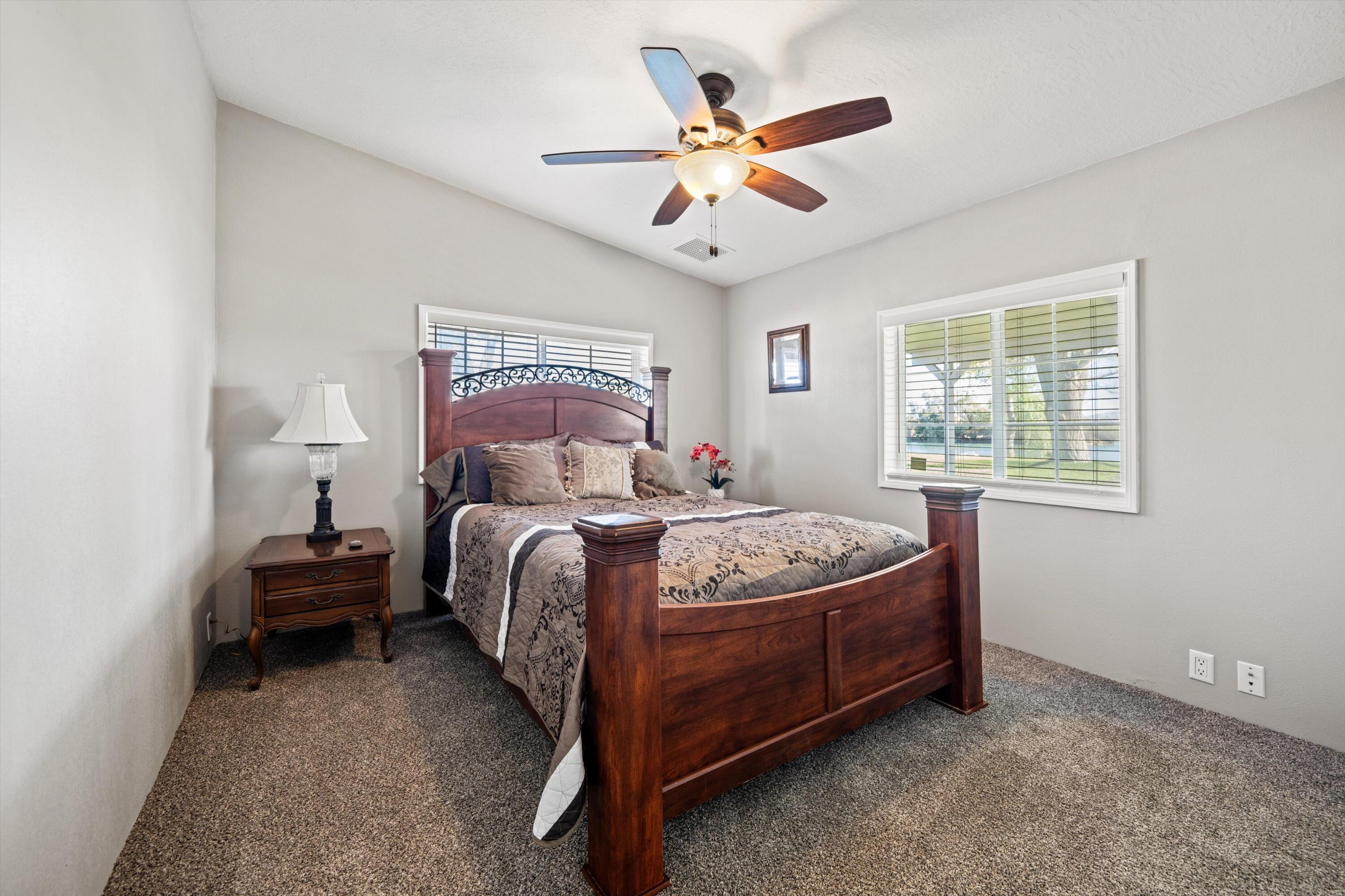 48197 Valley Center Road Newberry Springs, CA 92365 - Photo 18 of 32 a bedroom with a bed and a chandelier