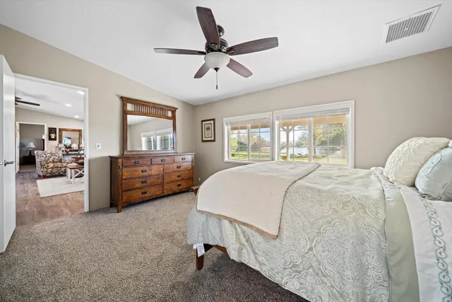 a bedroom with a bed and a large window