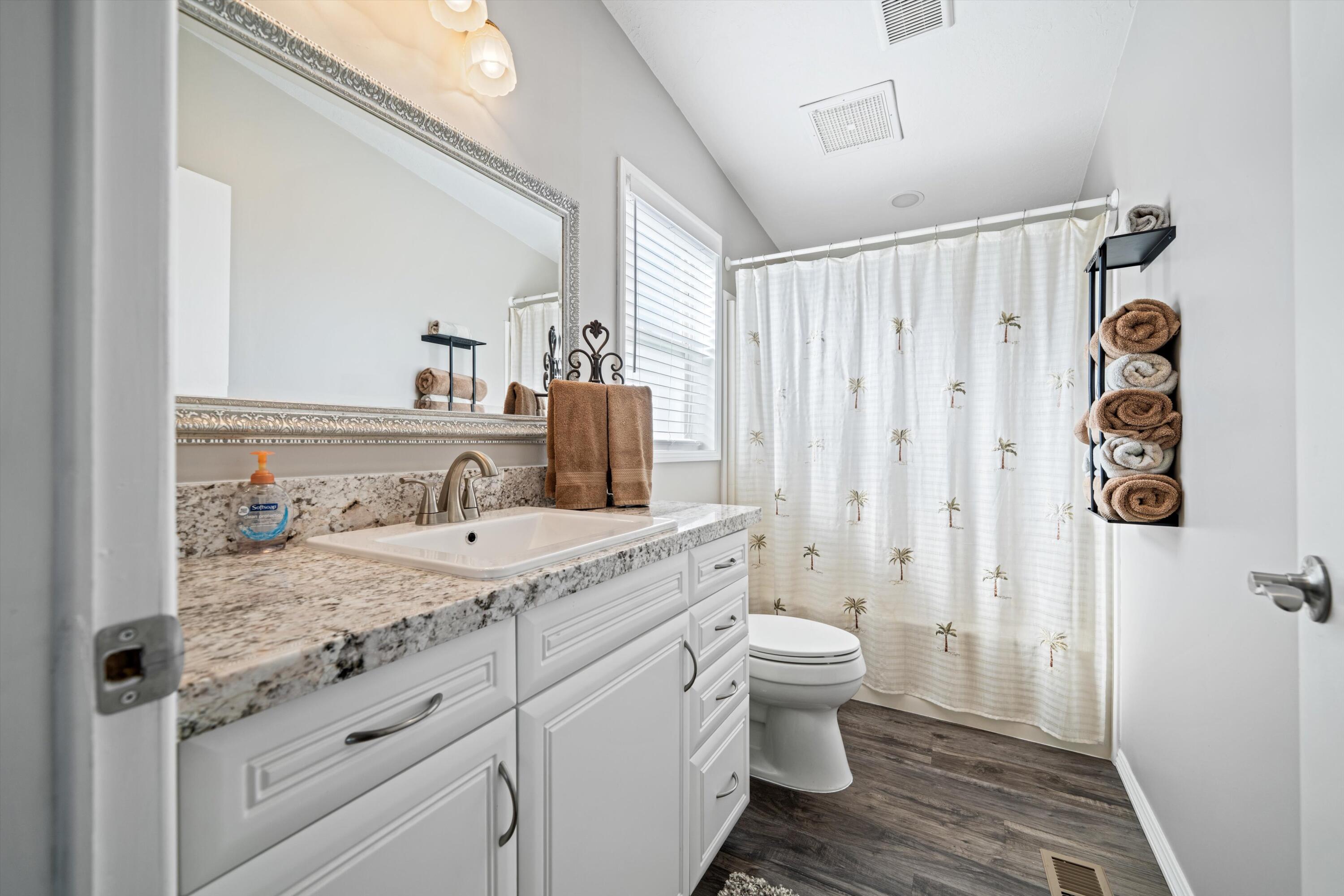 48197 Valley Center Road Newberry Springs, CA 92365 - Photo 21 of 32 a bathroom with a granite countertop sink toilet and shower