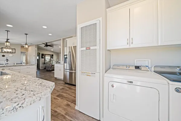 a kitchen with a sink a refrigerator and cabinets