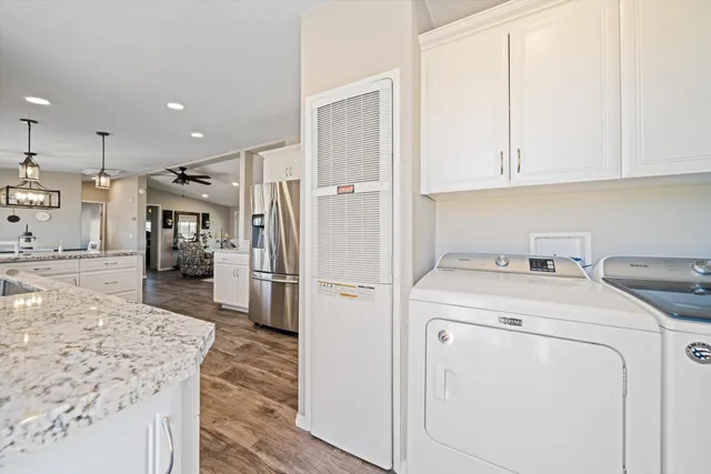 a kitchen with a sink a refrigerator and cabinets