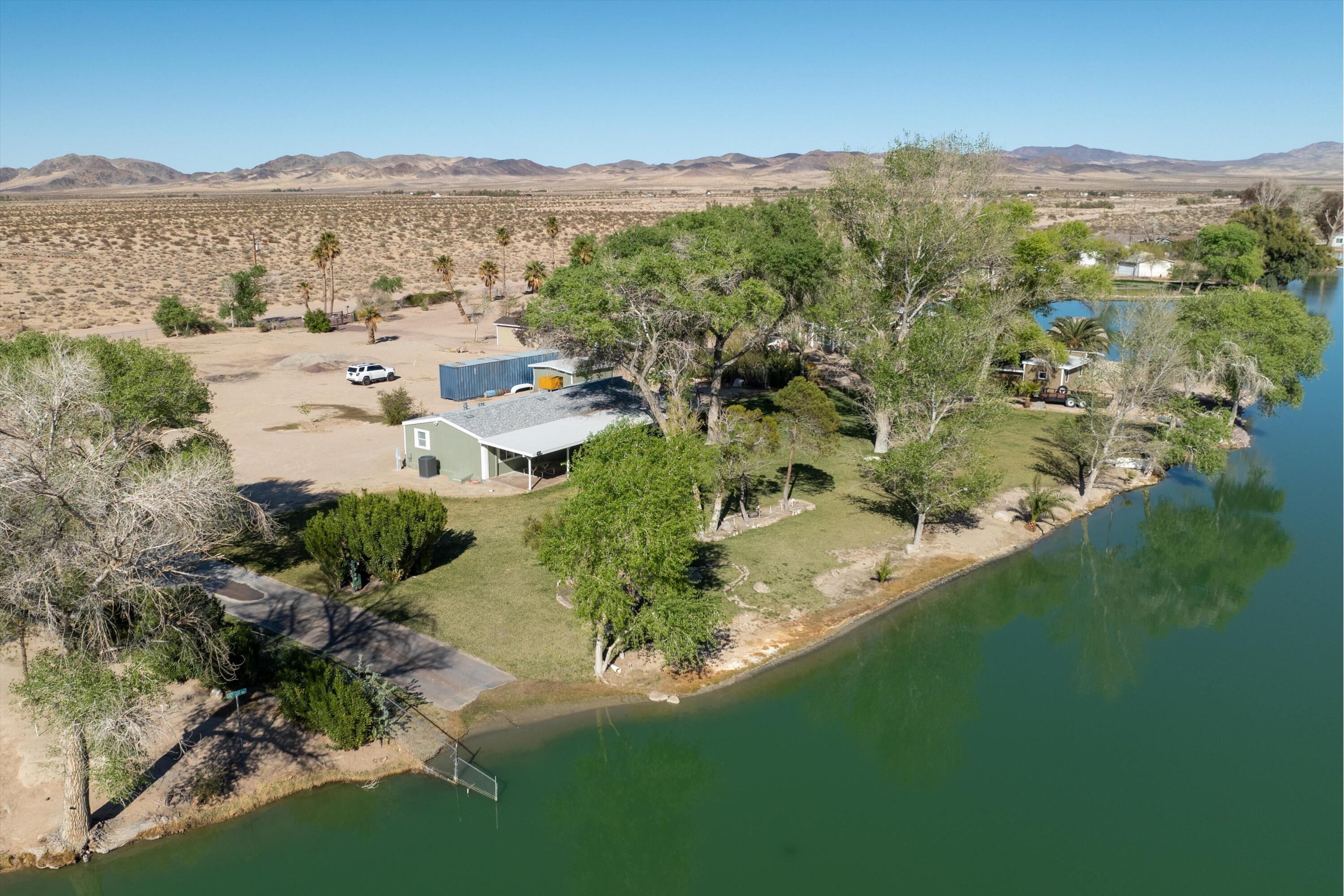 48197 Valley Center Road Newberry Springs, CA 92365 - Photo 26 of 32 an aerial view of residential houses with outdoor space and trees