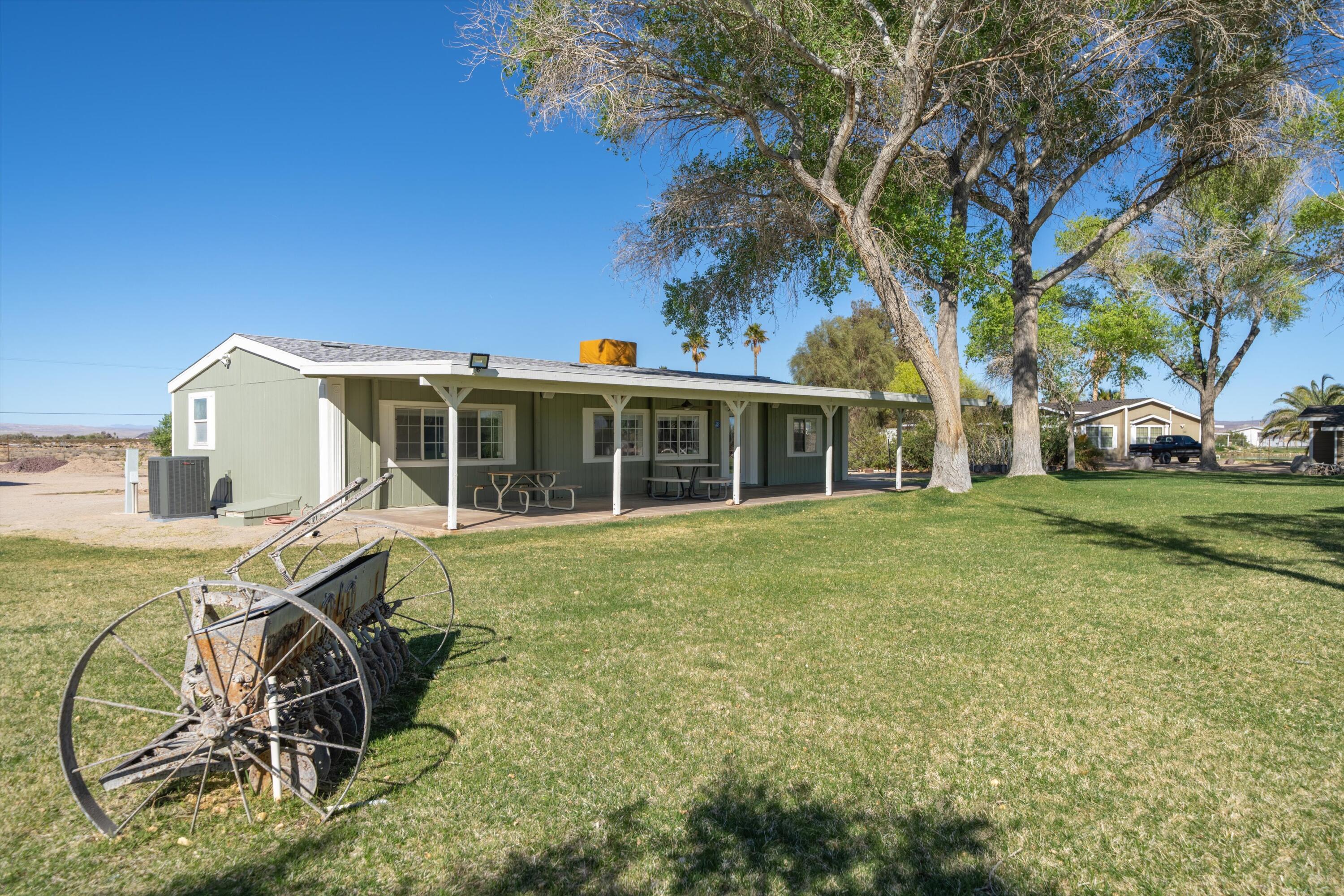 48197 Valley Center Road Newberry Springs, CA 92365 - Photo 5 of 32 a view of a house with a backyard