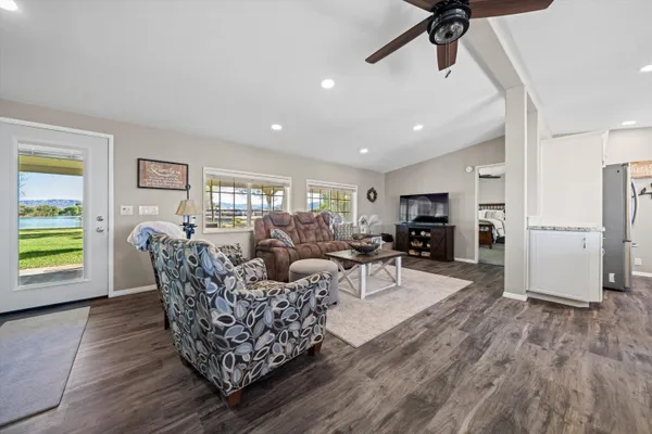a living room with furniture a wooden floor and a window