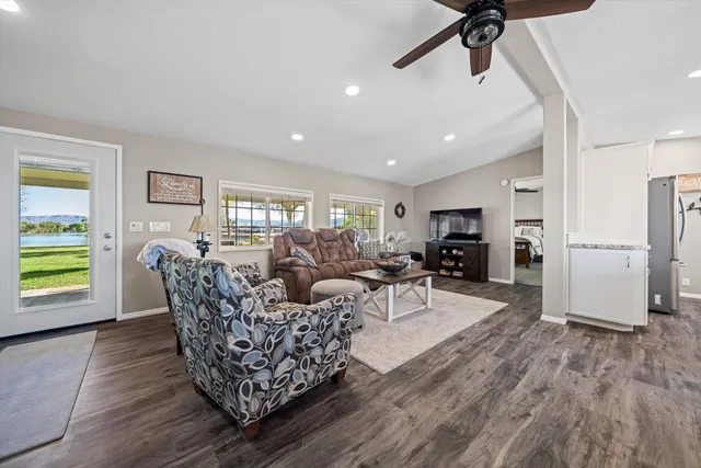 a living room with furniture a wooden floor and a window