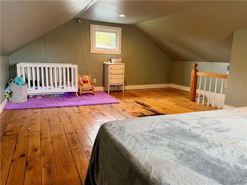 7468 Willey Road Hamilton, NY 13332 - Photo 11 of 19 Sloped ceilings and rich wide-plank wood floors define this cozy upper-level loft space.