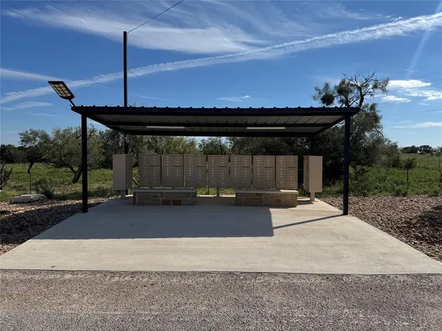 a backyard of a house with a table and chairs