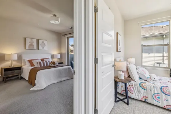 a bedroom with a bed and glass door