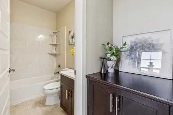 a view of an empty room with white walls and stairs