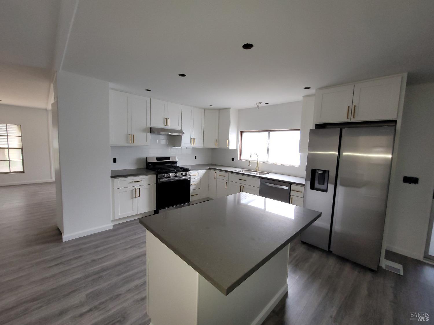 34 Sequoia Circle Santa Rosa, CA 95401 - Photo 1 of 1 a kitchen with stainless steel appliances granite countertop a refrigerator a stove a sink a microwave and white cabinets with wooden floor
