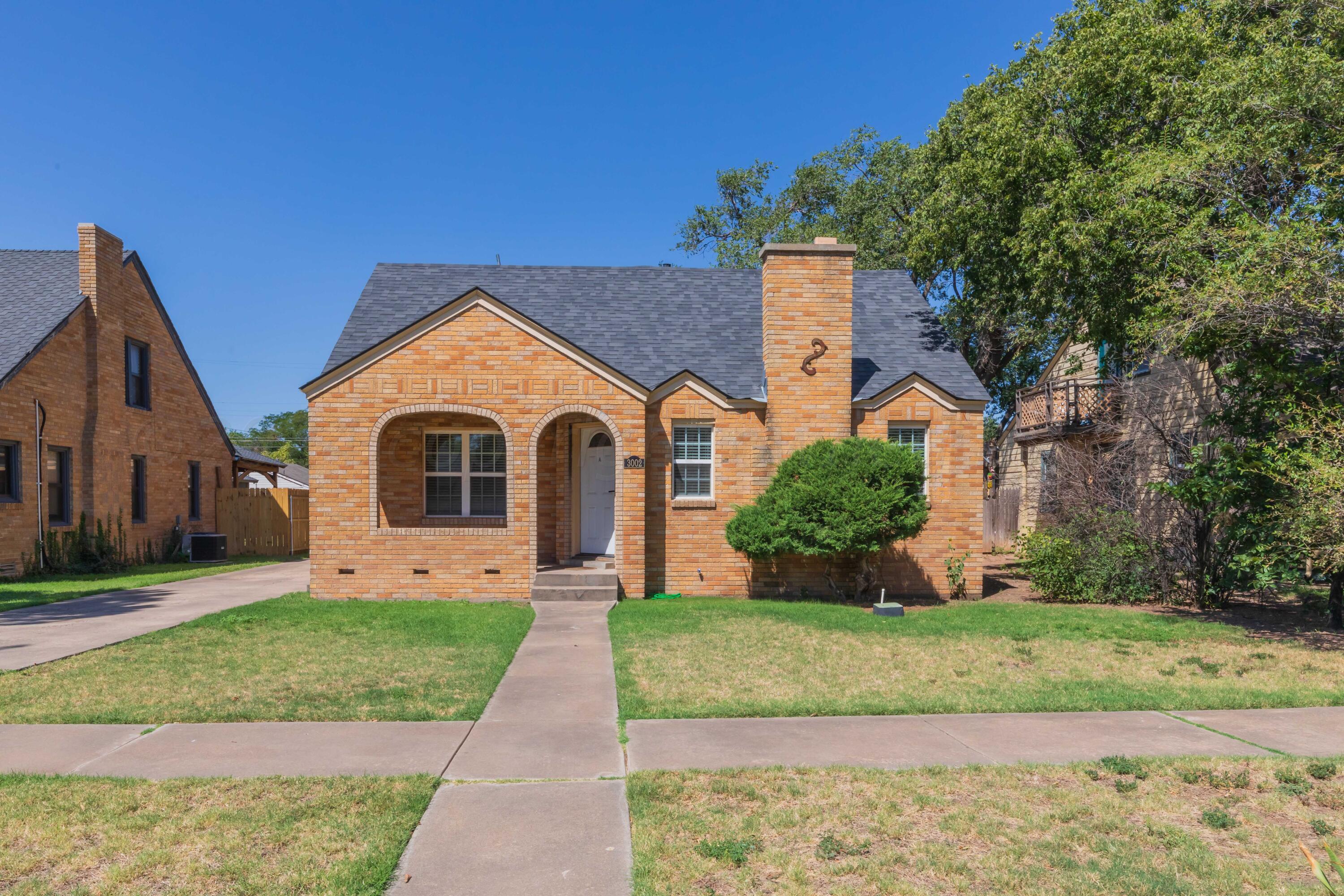 3002 South Polk Street Amarillo, TX 79109 - Photo 1 of 36 a front view of a house with a yard
