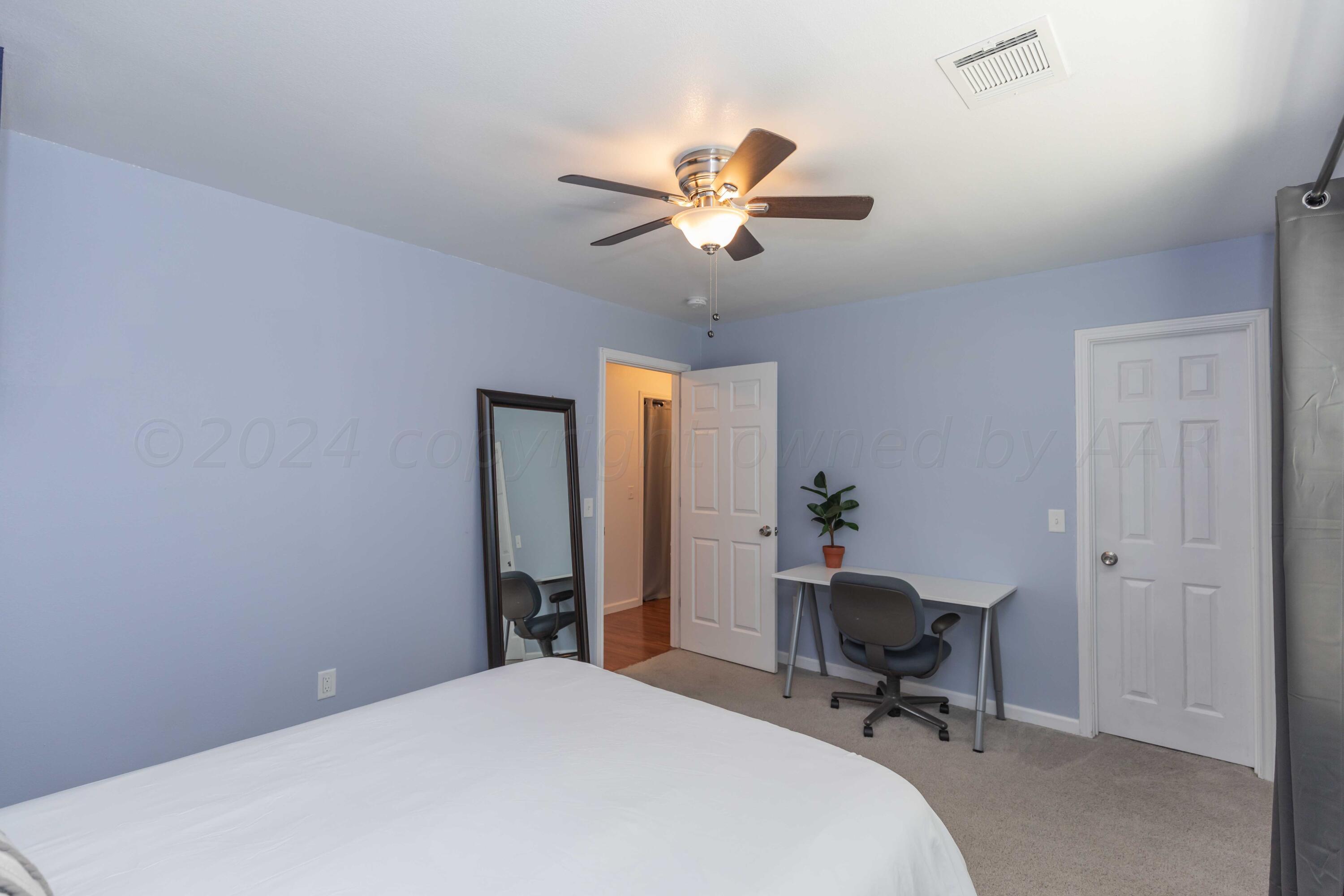 3002 South Polk Street Amarillo, TX 79109 - Photo 25 of 36 a workspace with chandelier fan and a window