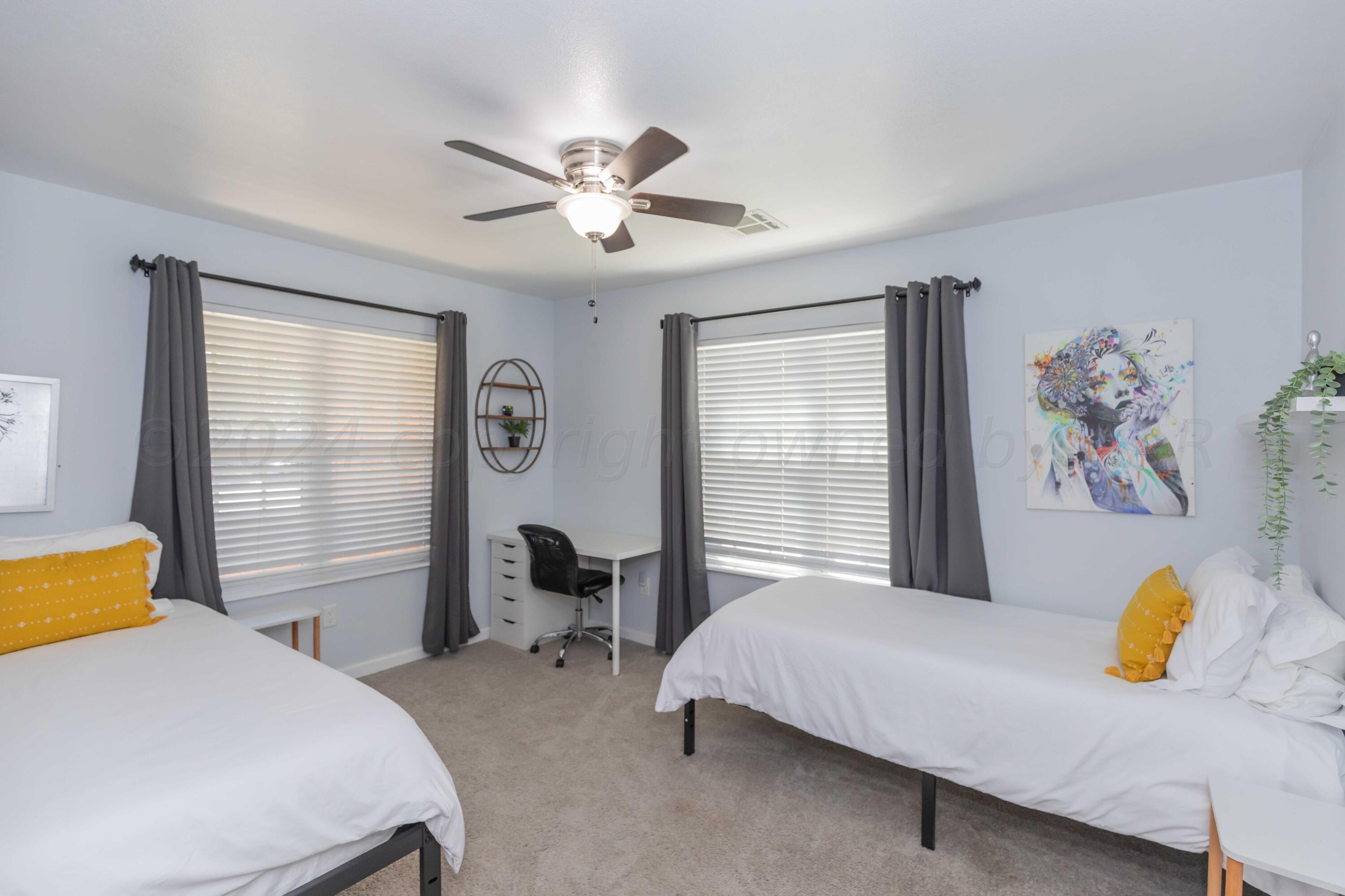 3002 South Polk Street Amarillo, TX 79109 - Photo 30 of 36 a bedroom with a bed and a chandelier