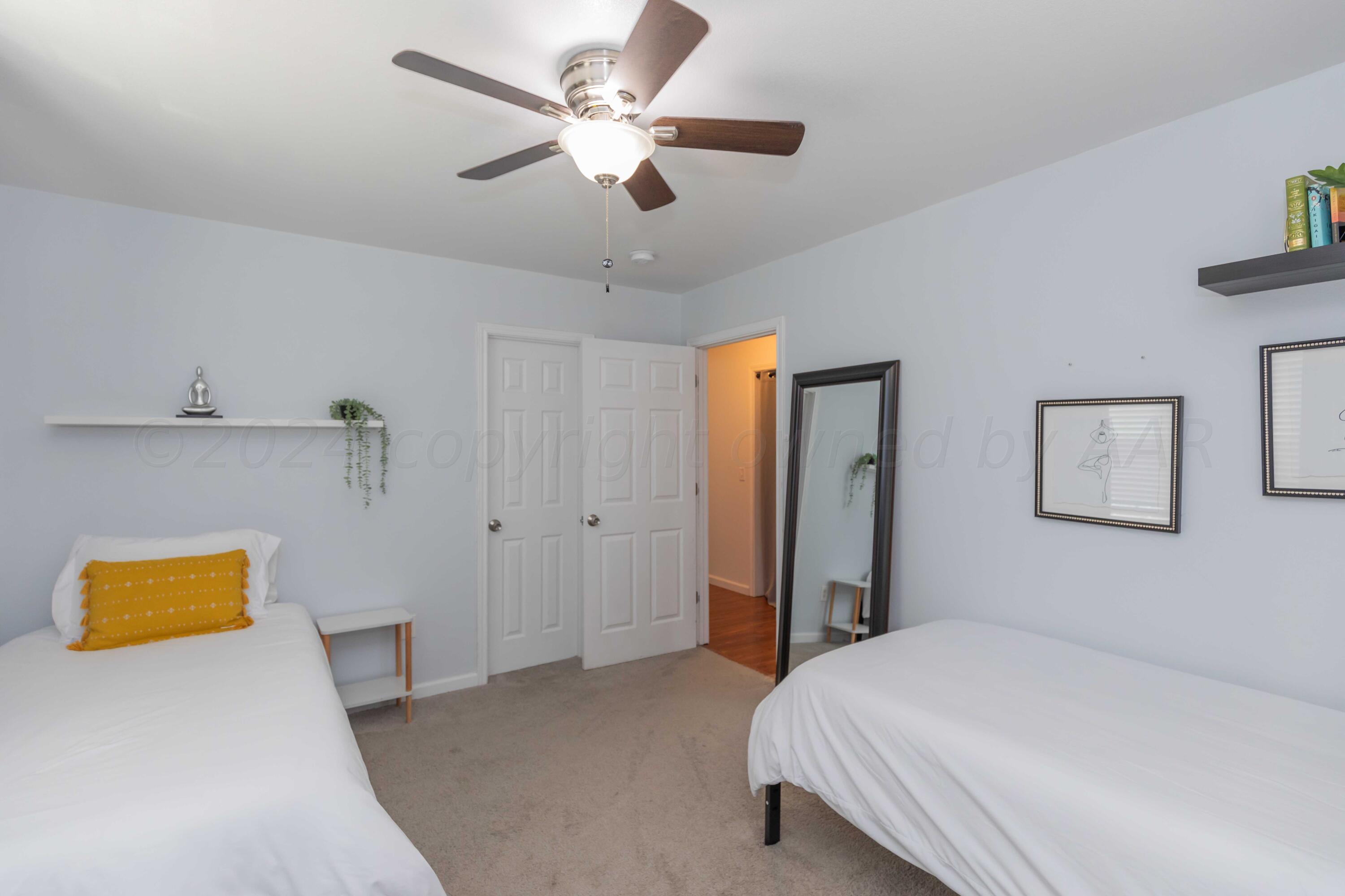 3002 South Polk Street Amarillo, TX 79109 - Photo 32 of 36 a bedroom with a bed and a chandelier